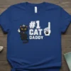 #1 Cat Daddy t-shirt design with a crowned cat holding a finger up and a foam finger with a paw