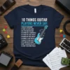 Navy t-shirt with the text "10 Things Guitar Players Never Say" and a list of funny sayings for guitarists, featuring