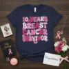 10 Years Breast Cancer Survivor text design with pink ribbon and flowers on a navy t-shirt