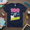 100 Days Bruh t-shirt with a pink 100, a blue rocket, and "DAYS BRUH" in yellow text