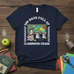 T-shirt design with text "100 Days Full of Classroom Chaos" featuring three raccoons and school elements on a navy shirt