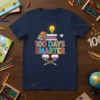 100 Days Smarter t-shirt with colorful text, books, lightbulb, and heart-shaped glasses graphic for 100th day of school