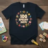 100 Spechy Days text with playful graphics including lips, flowers, and a brain, on a navy t-shirt