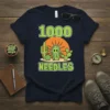 1000 Needles t-shirt design featuring a cartoon cactus with many spines, desert background, and playful typography