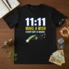 Black t-shirt with "11:11 Make A Wish Every Day Is Magic" text and a shooting star with rainbow and dandelions