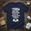 Navy blue t-shirt featuring the quote '1984 Was Not Supposed To Be An Instruction Manual' with a surveillance camera and