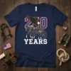 20 Years t-shirt design with an eagle flying over a horse-drawn carriage, celebrating American history