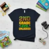 2nd Grade Level Unlocked t-shirt with pixelated text and gaming-themed elements