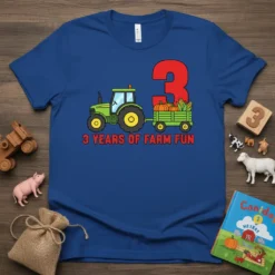 Blue t-shirt with "3 Years Of Farm Fun" text, a green tractor, and a wagon filled with pumpkins and corn