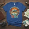 40 Years of Being Awesome Vintage 1984 text with mountains and waves graphic on a blue t-shirt