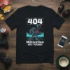 Black t-shirt with "404 Motivation NOT FOUND!" text and a retro robot graphic, featuring neon blue and pink accents