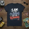 5 AM Is For Clubbing Not For Running text design on a navy blue t-shirt, featuring bold white, pink, and