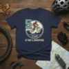 50 Years of Dirt & Adventure text with a mountain biker graphic on a navy blue t-shirt