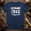 The ∛512 YEARS OLD t-shirt design features a cube root symbol over 512 with text below, printed in white on