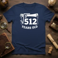 The ∛512 YEARS OLD t-shirt design features a cube root symbol over 512 with text below, printed in white on