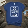 55 And Still Alive t-shirt design with retro car driving on a mountain road under a sunset