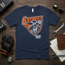 6 STREET MIAMI 2024 t-shirt design with orange and white text and a graphic of a V8 engine, presented on