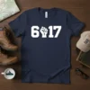 Navy blue t-shirt with bold white "617" text and a raised fist graphic in place of the number '1'