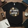 Black t-shirt with "67 DAYS LATER" and "DAY 67" text surrounded by gears and clocks graphic