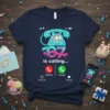 T-shirt with "67 is calling..." text and a retro teal rotary phone graphic, representing a 67th birthday