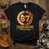 67 Thanksgiving Blessings text with pie and turkey legs graphic on black t-shirt