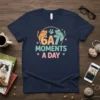 Navy t-shirt with "6A7 Moments A Day" text and cute cartoon cats and paw prints
