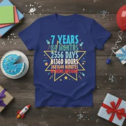 Blue t-shirt with colorful text detailing '7 Years 84 Months 2556 Days 61360 Hours 3681644 Minutes Of Being Awesome' for