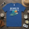 80 Days To Summer Vacay t-shirt with a vintage convertible driving towards a sunset beach scene and palm trees