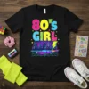 80'S GIRL text in bright neon colors with a retro cityscape and purple car graphic