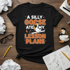 A Silly Goose Ate My Lesson Plans quote on a black t-shirt, featuring a cartoon goose holding a pencil and