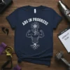 Abs In Progress t-shirt featuring a muscular torso with a flower growing from the head and bold white text above