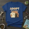 ADOPT don't shop t-shirt with a happy dog being petted next to a black cat, featuring paw prints