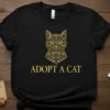 Black t-shirt with gold ornate cat head graphic and "ADOPT A CAT" text