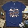 Adoption IS A BEAUTIFUL Thing quote t-shirt with intertwined hands graphic and hearts