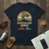 Adrenaline Junkie t-shirt design featuring a quad biker jumping over mountains with retro sunset and ATV graphics