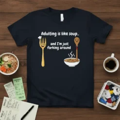 T-shirt design featuring the quote "Adulting is like soup.. and I'm just forking around" with cartoon fork and spoon characters