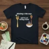 T-shirt with white text "Adulting is like soup.. and I'm just forking around" featuring a fork character and a sad
