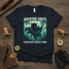 T-shirt with "Adventure Awaits Explore With Your Best Friend" text, showing a T-Rex carrying a person in a cowboy hat