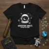 Astronaut helmet graphic with planets and stars, text reads "Adventure Awaits Explore The Cosmos" on a black t-shirt