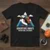 Black t-shirt with "ADVENTURE AWAITS PUFFIN TRAIL EXPLORERS" text and a puffin graphic for the Puffin Trail Explorers theme