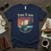 Sailboat on water with cityscape sunset graphic and text "Adventure Awaits The Future" on navy t-shirt