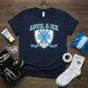 Navy blue t-shirt with "Advil & Ice" text above a shield with crossed hockey sticks and a hockey puck