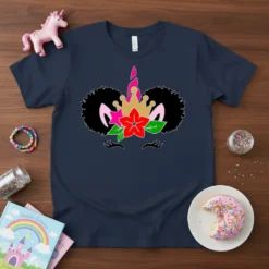 Afro unicorn girl face graphic with a crown, pink ears, red flower, and black afro hairstyle on a navy t-shirt