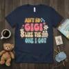 Ain't No Gigi Like The One I Got text in retro font with flowers and books, navy blue t-shirt design