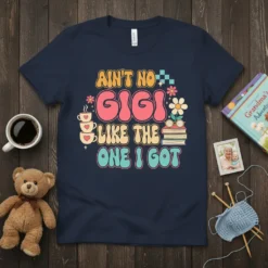 Ain't No Gigi Like The One I Got text in retro font with flowers and books, navy blue t-shirt design