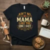 Ain't No Mama Like The One I Got quote on a black t-shirt, featuring decorative elements and a heart graphic