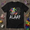 Black t-shirt with bold white "ALAAF" text and colorful Mardi Gras carnival graphics including a jester hat and mask