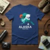 Alaska Since 1959 T-Shirt featuring a white bear graphic on a map of Alaska with a sailboat and sun