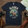 Alaska The Last Frontier Est 1959 t-shirt design featuring a bear, mountains, and aurora borealis under a vintage circle graphic