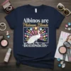 T-shirt with text "Albinos are Platinum Blonde Bombshells" and a graphic of a white albino peacock with colorful abstract background